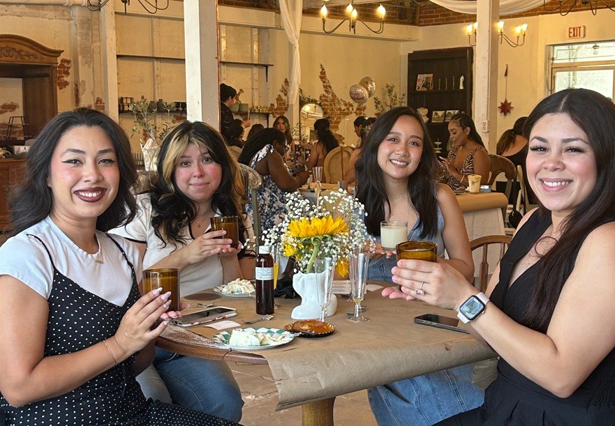 Group of guests smiling at a Candelitas candle making workshop